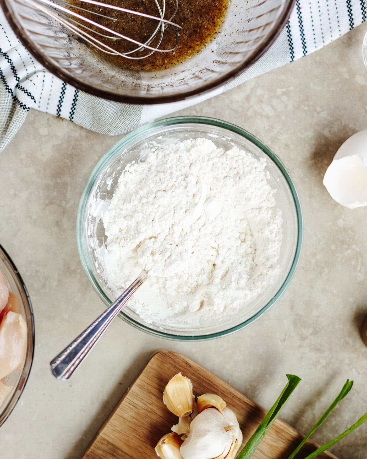 Cornstarch and flour combined in a small glass bowl.