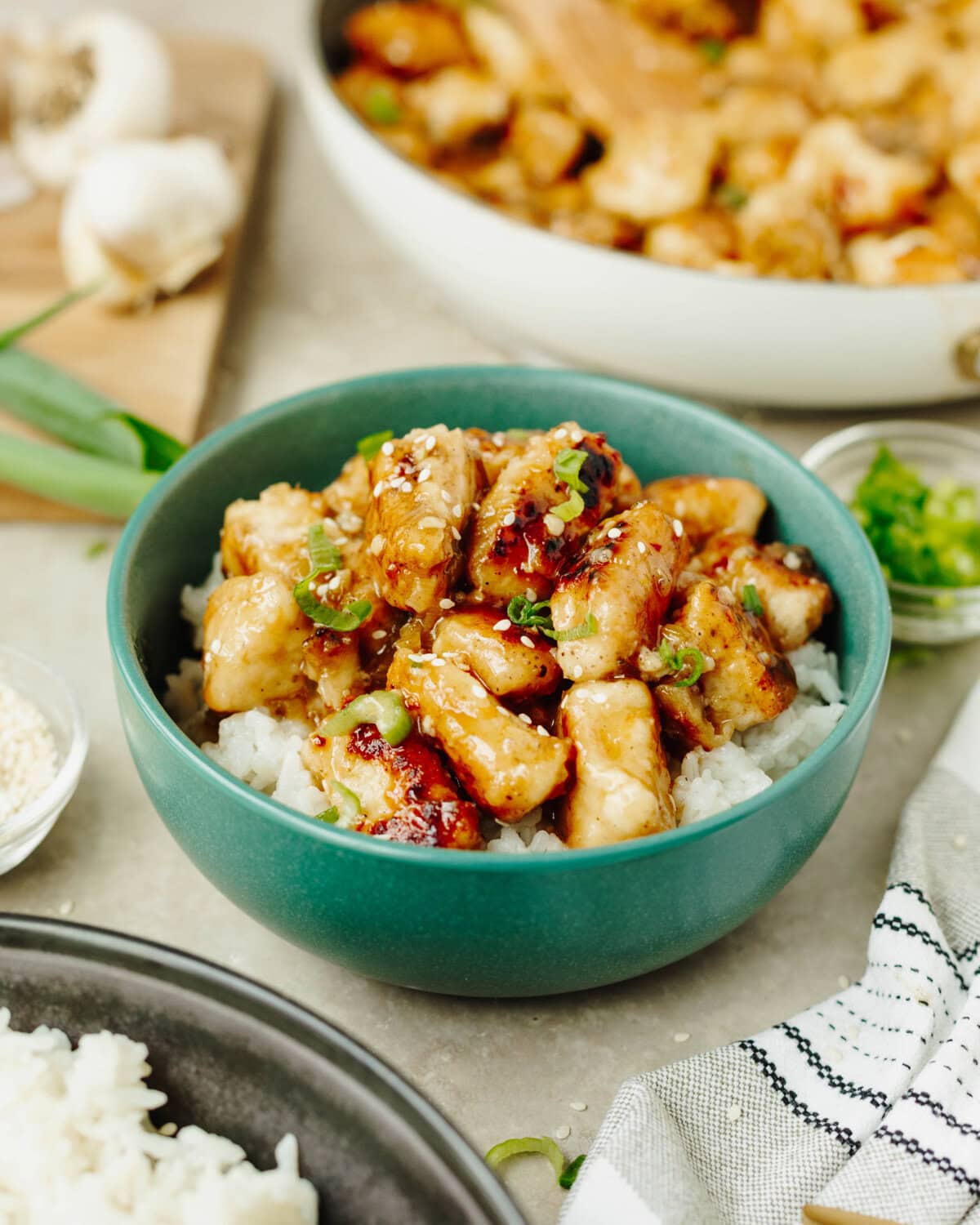 Easy Orange Chicken served over white rice in a blue bowl.