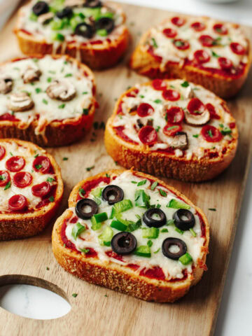 Baked garlic toast with pizza sauce, cheese, and toppings.