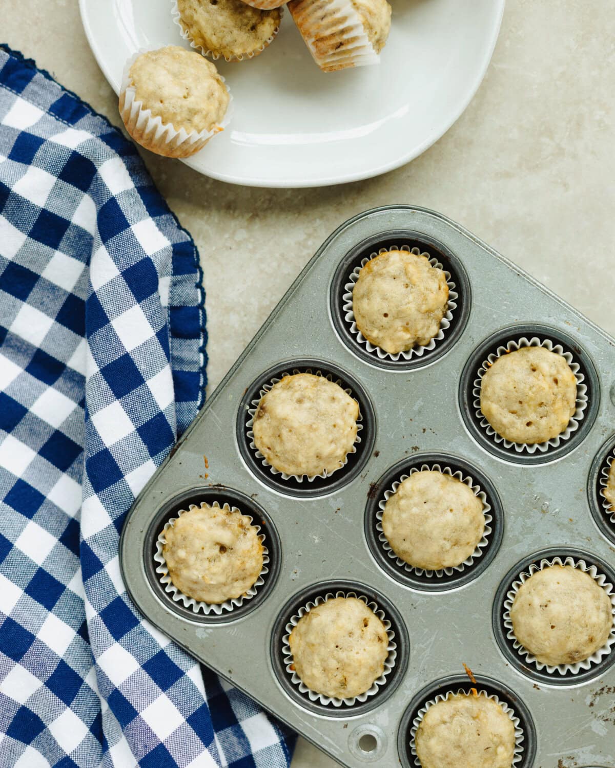 Baked mini banana muffins in a muffin pan.