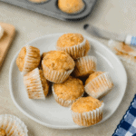 A white plate with mini banana muffins ready to serve.