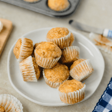 A white plate with mini banana muffins ready to serve.