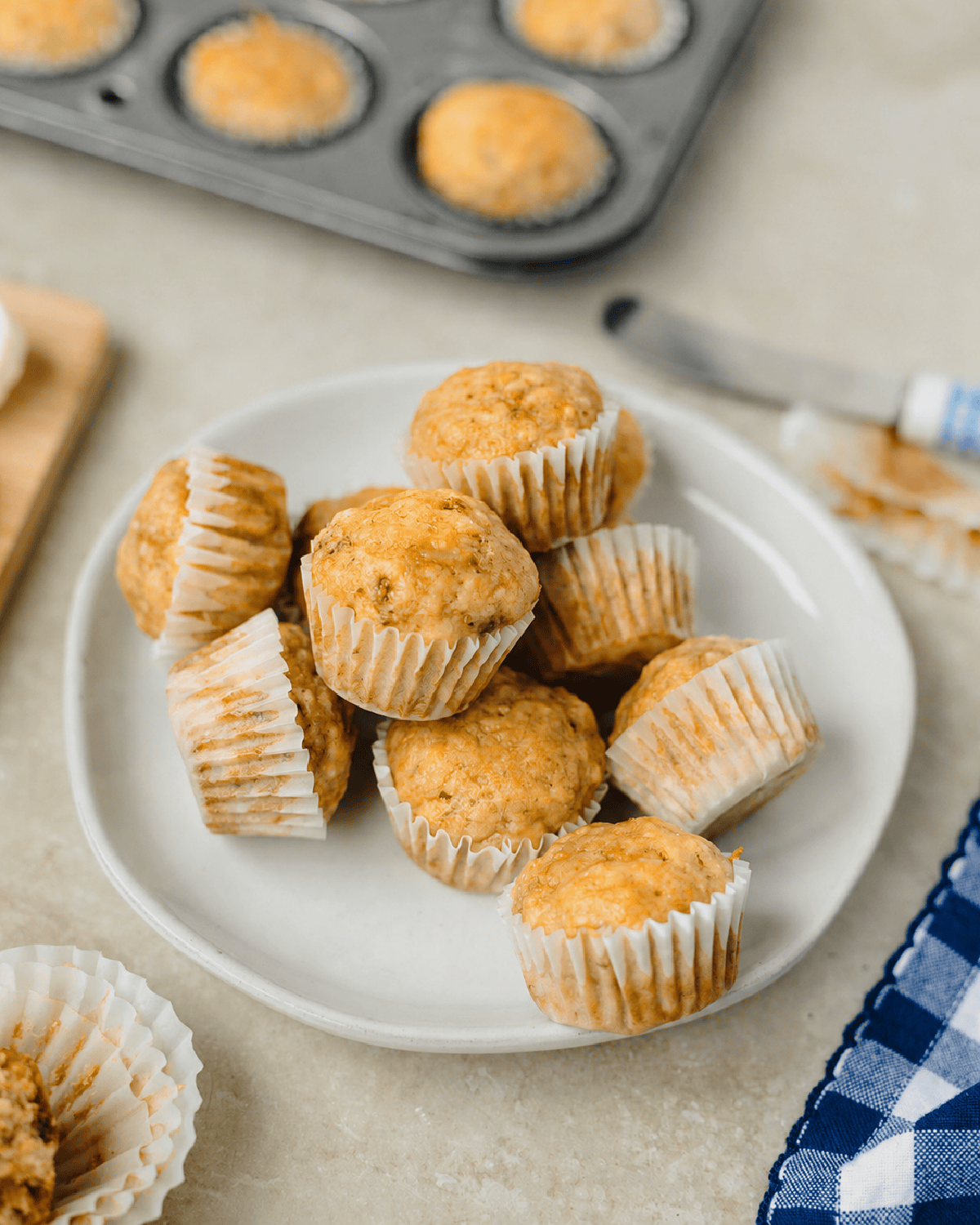 A white plate with mini banana muffins ready to serve.
