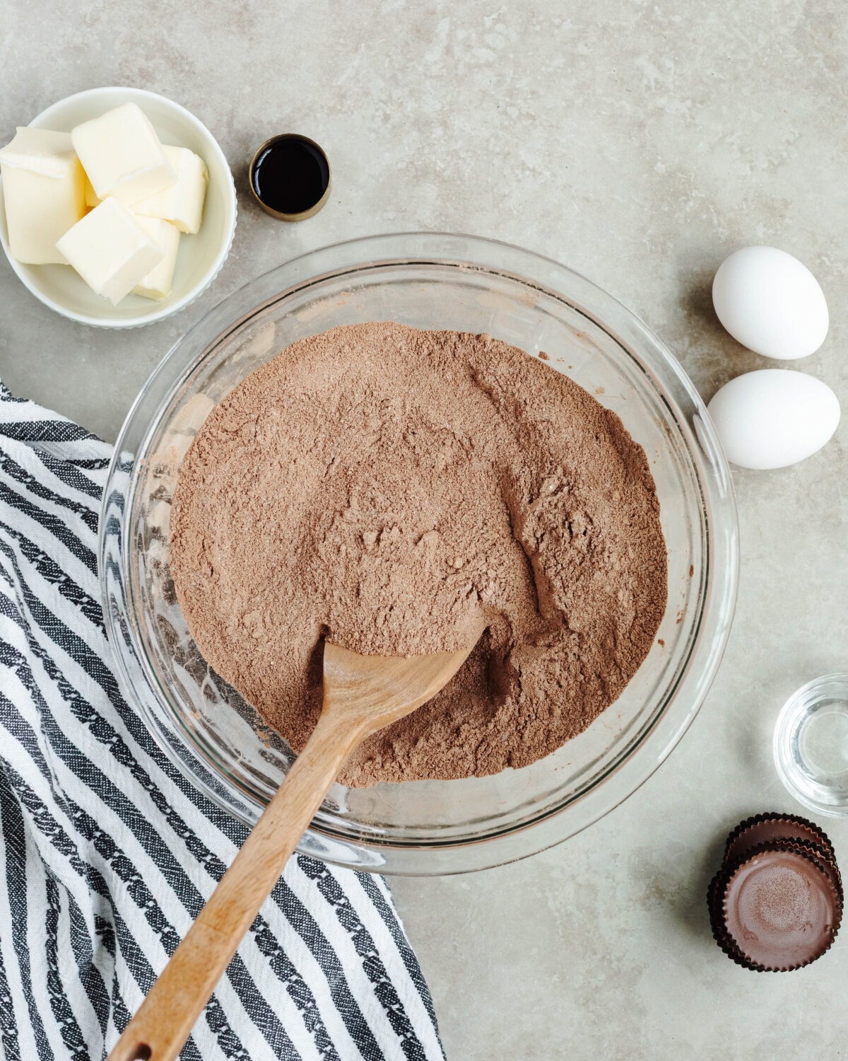 Cocoa powder, sugar, flour, baking powder, and salt combined in a glass bowl.