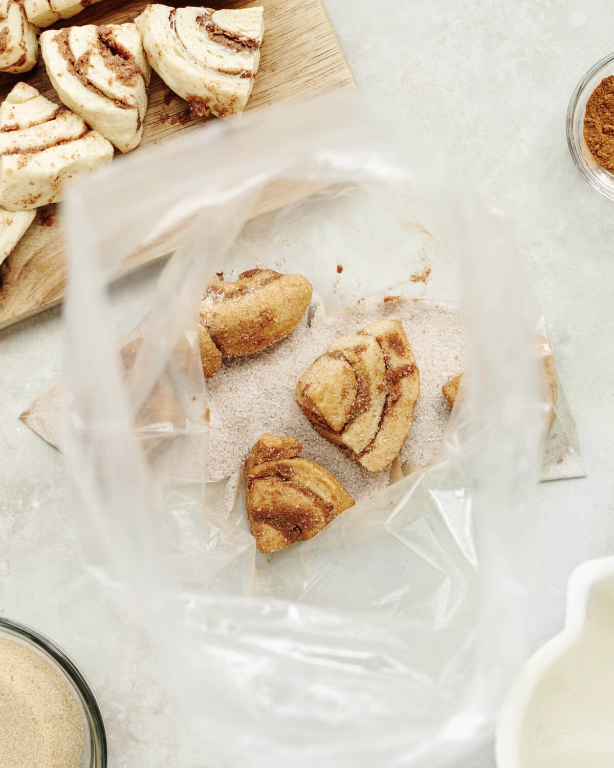 Cinnamon roll pieces dipped into a cinnamon sugar mixture.