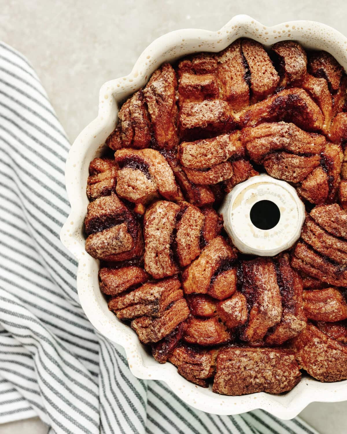 Baked pumpkin spice monkey bread in a white bundt pan.