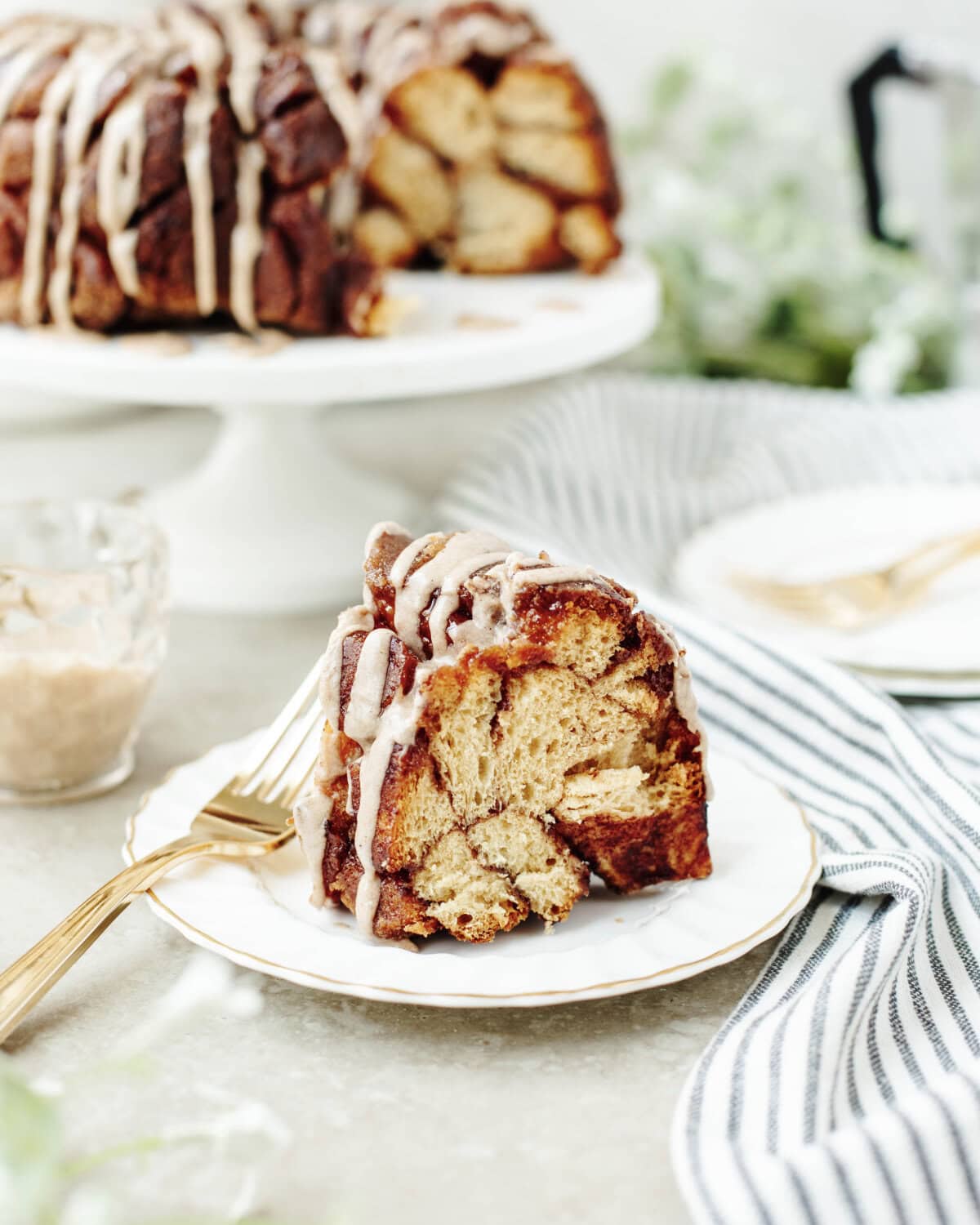 A slice of pumpkin spice monkey bread on a white plate ready to enjoy.