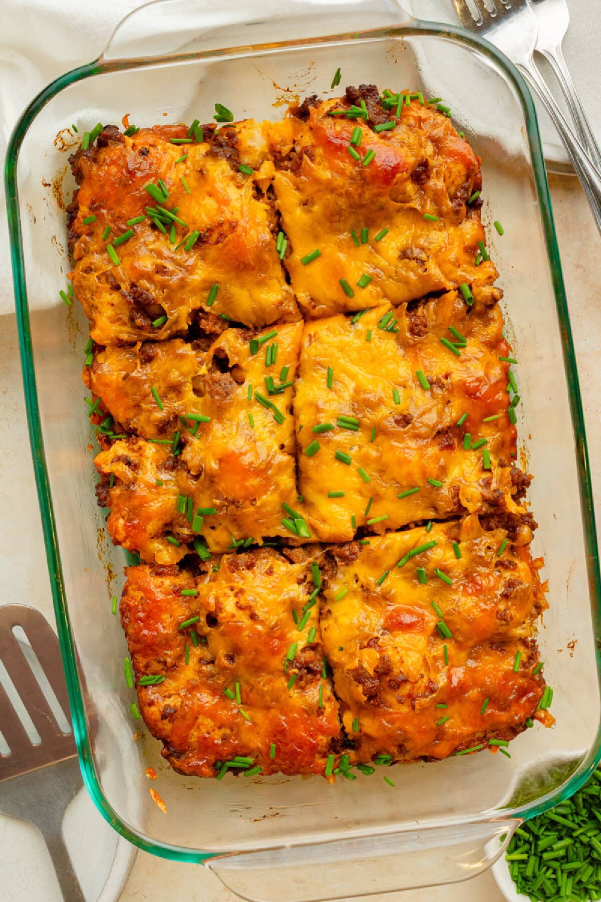 Baked sloppy joe biscuit casserole fresh from the oven in a glass 9x13 baking pan.