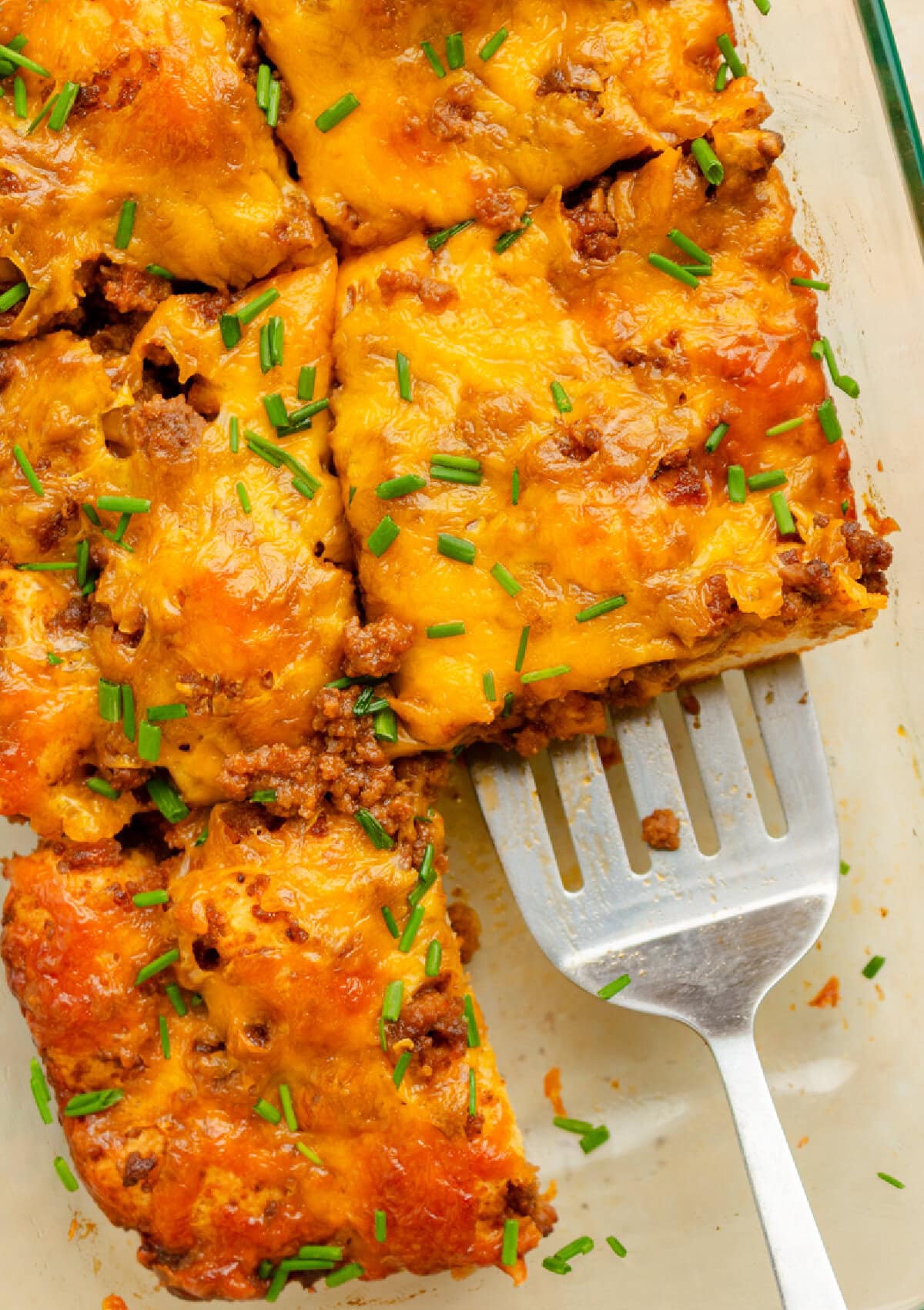A spatula serving a piece of sloppy joe casserole.
