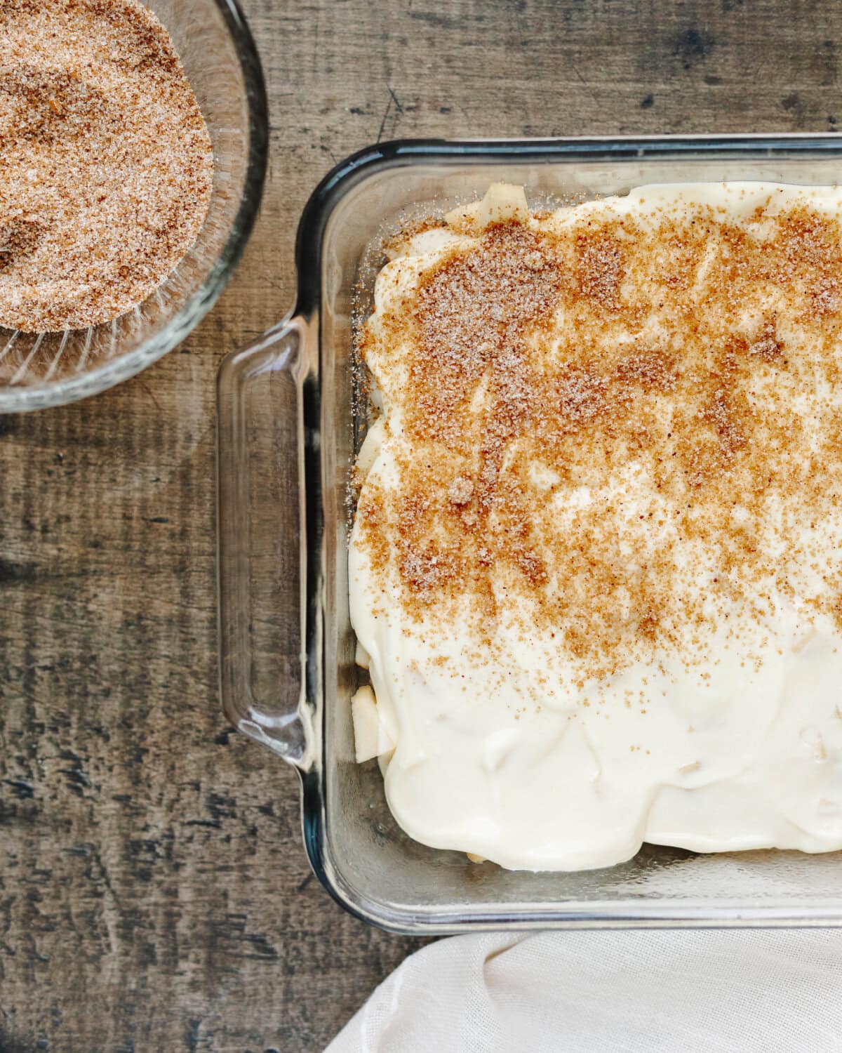 Brown sugar, cinnamon, sugar, and nutmeg combined and sprinkled on top of a cream cheese mixture.