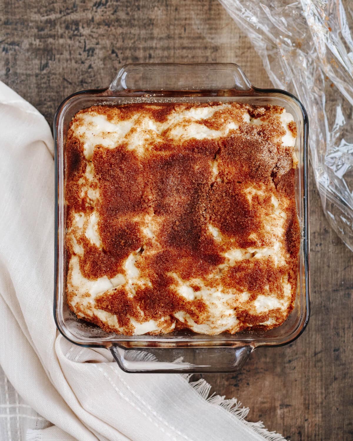 Baked apple cinnamon cream cheese bake in a glass 8x8 baking pan.