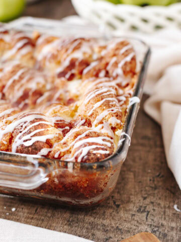 A side view of apple cinnamon cream cheese bake in a glass baking dish.