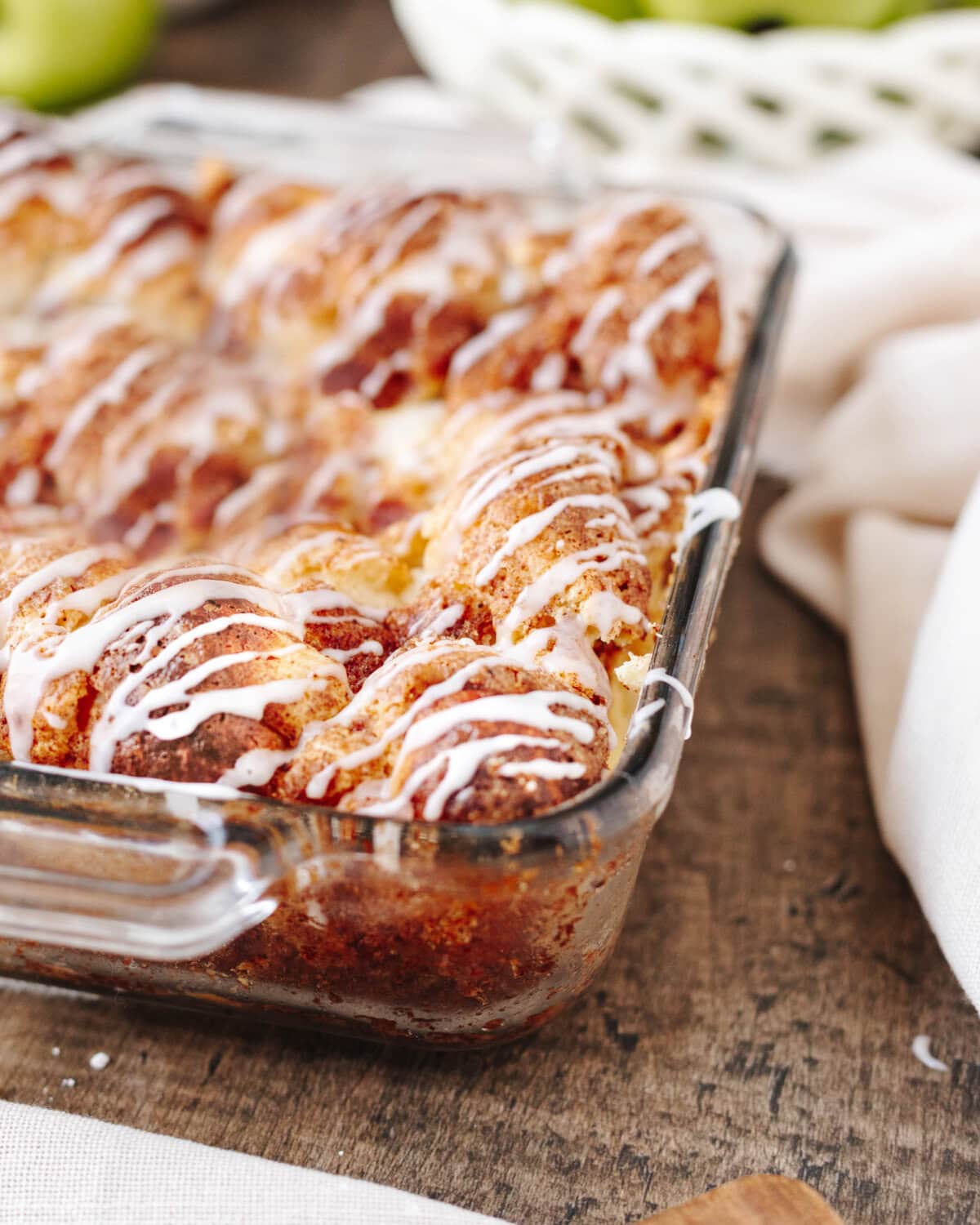 A side view of apple cinnamon cream cheese bake in a glass baking dish.