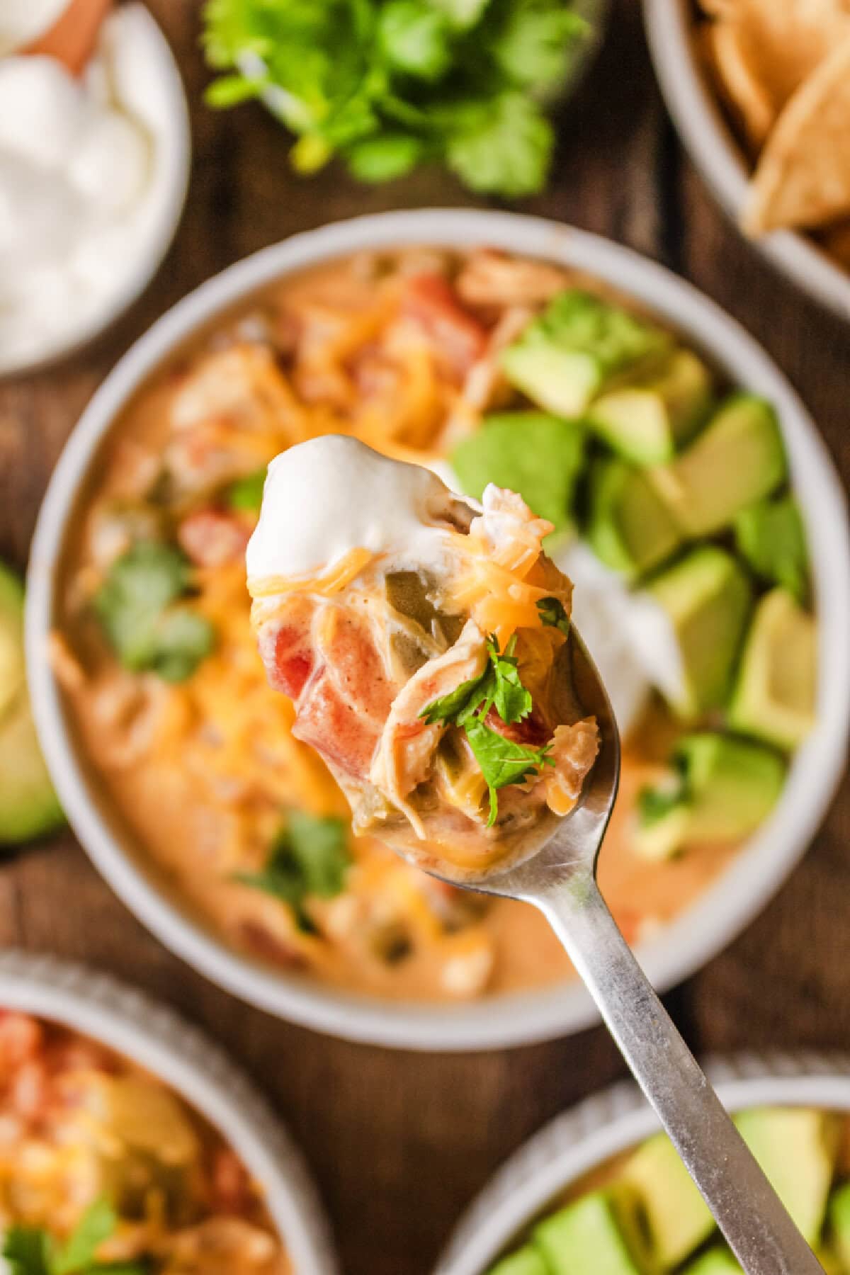 A spoonful of creamy chicken fajita soup from a bowl.