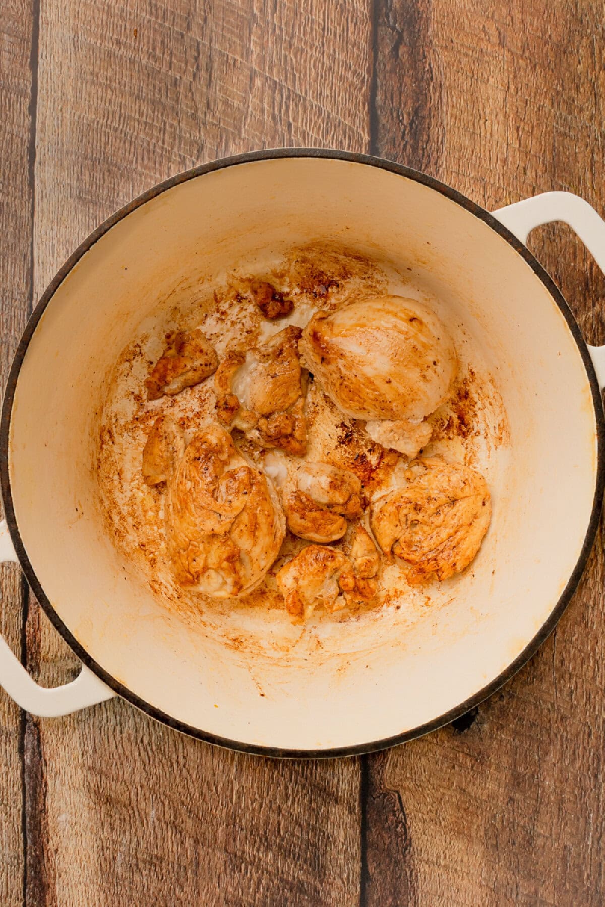 Chicken browning in a Dutch oven for chicken and sausage gumbo.