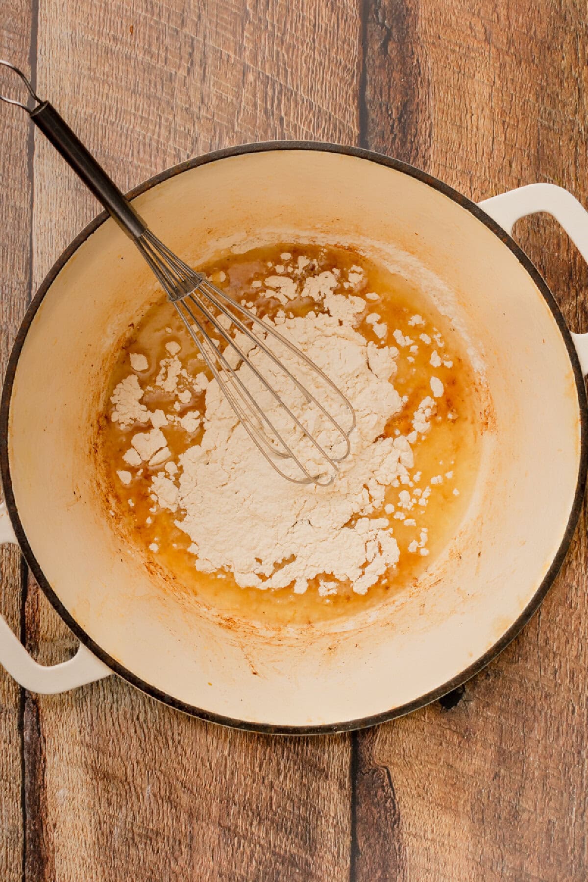 Vegetable oil and flour added to a Dutch oven.