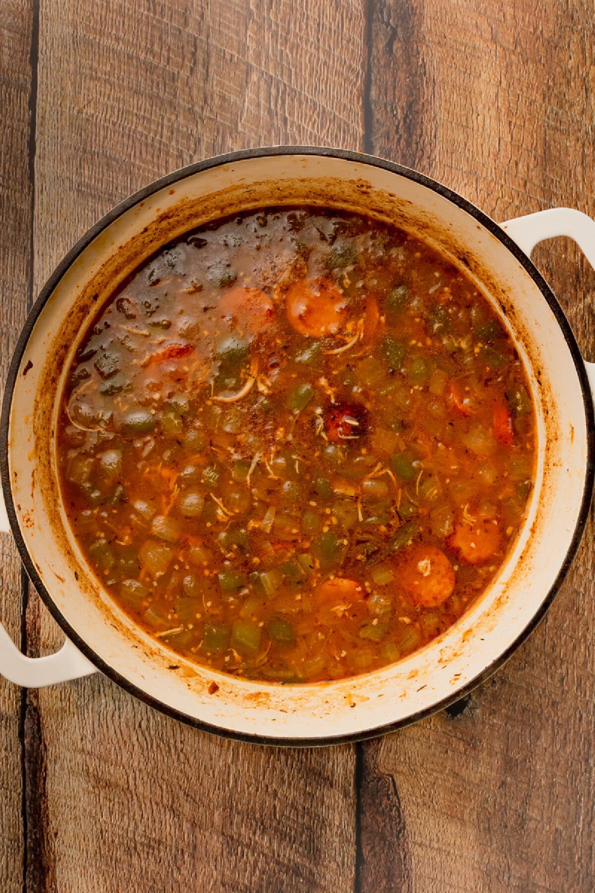 Chicken and sausage gumbo simmering in a Dutch oven.