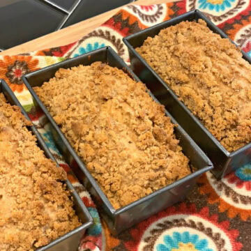 Mini loaves of cinnamon crumble banana bread in loaf pans.