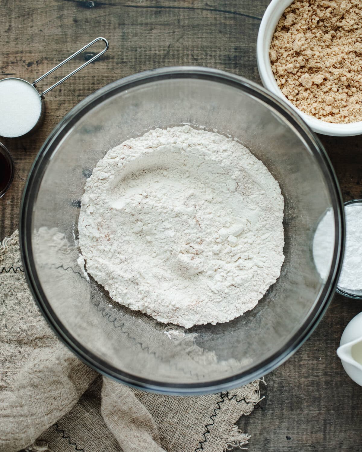 Flour, baking power, cinnamon, and salt sifted together in a glass bowl.
