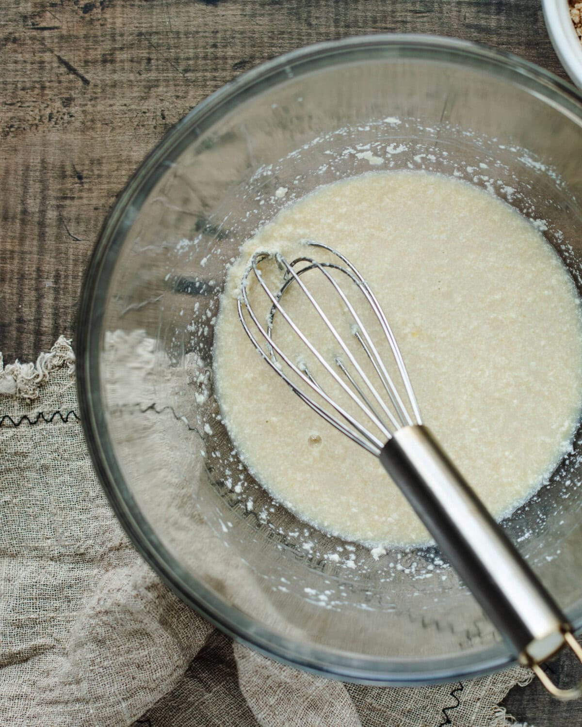 Sugar, egg, and melted butter combined in a mixing bowl.