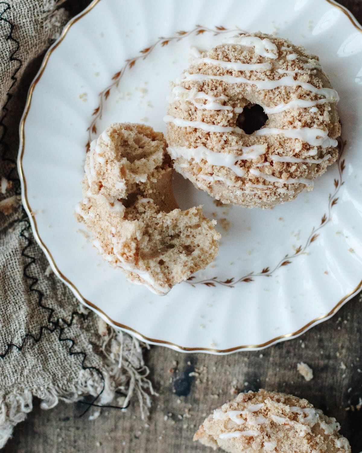 Coffee cake donuts on a white serving plate.