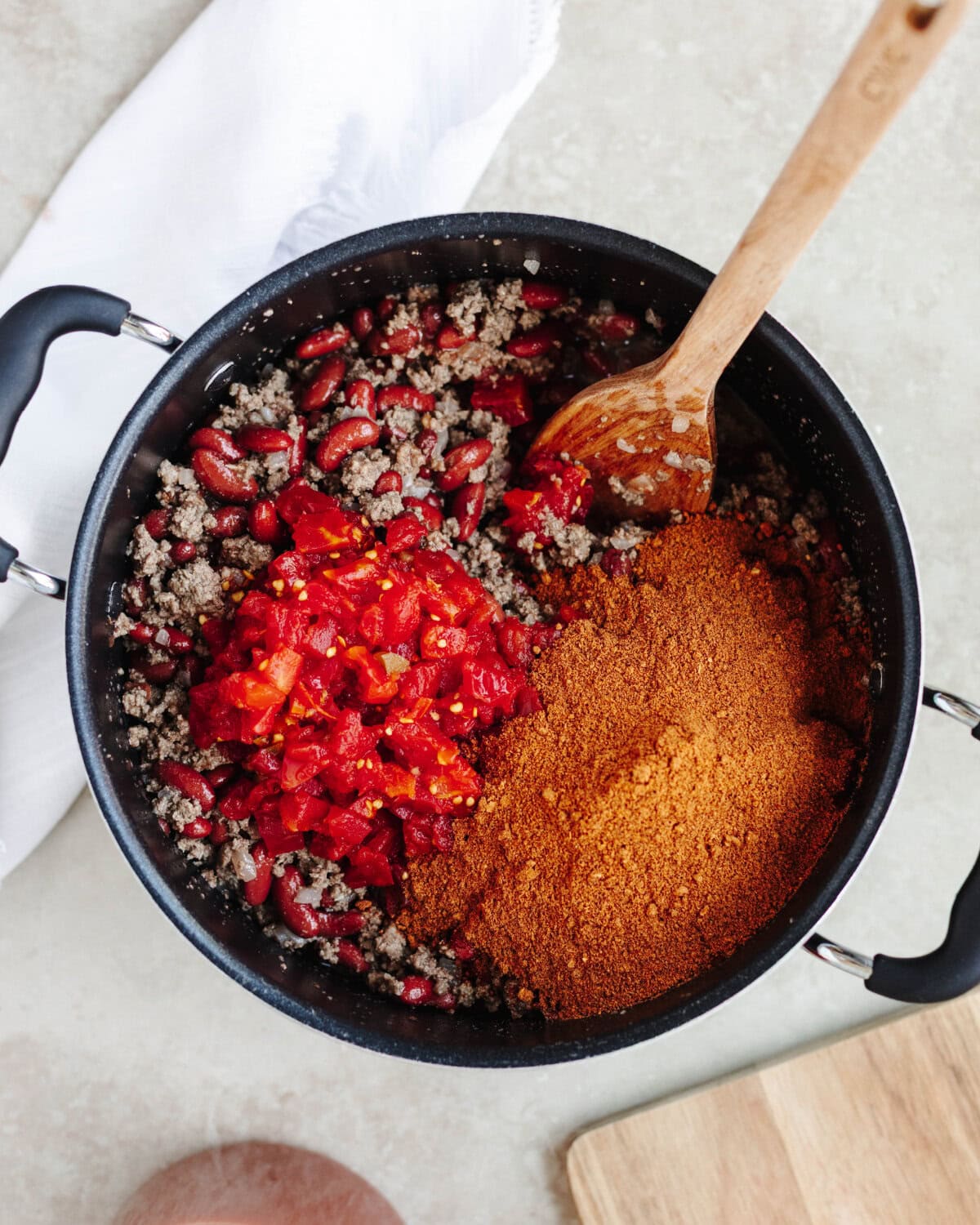 Tomatoes and chili seasoning added to ground beef and beans.
