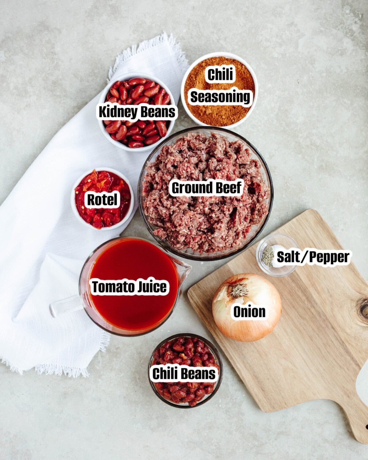 Ingredients for homemade beef chili including ground beef, beans, tomatoes, and V-8 juice.