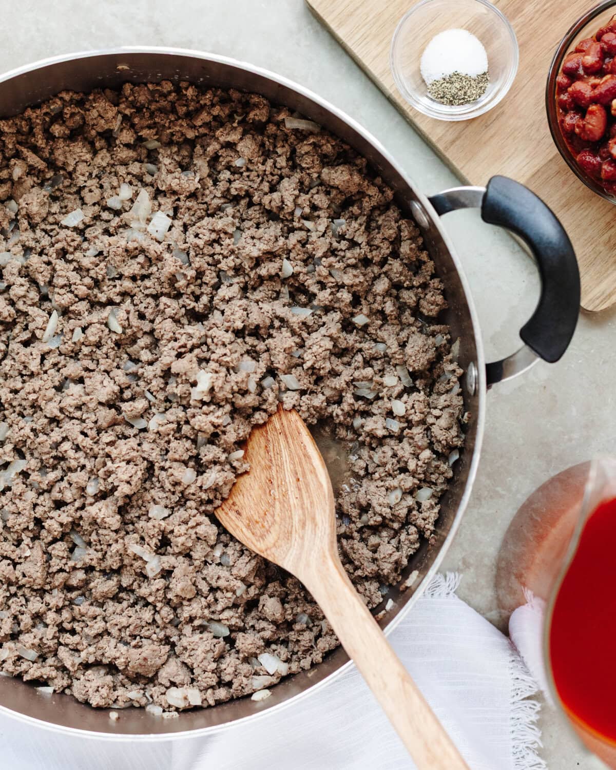 Ground beef and diced onion browning in a Dutch oven.