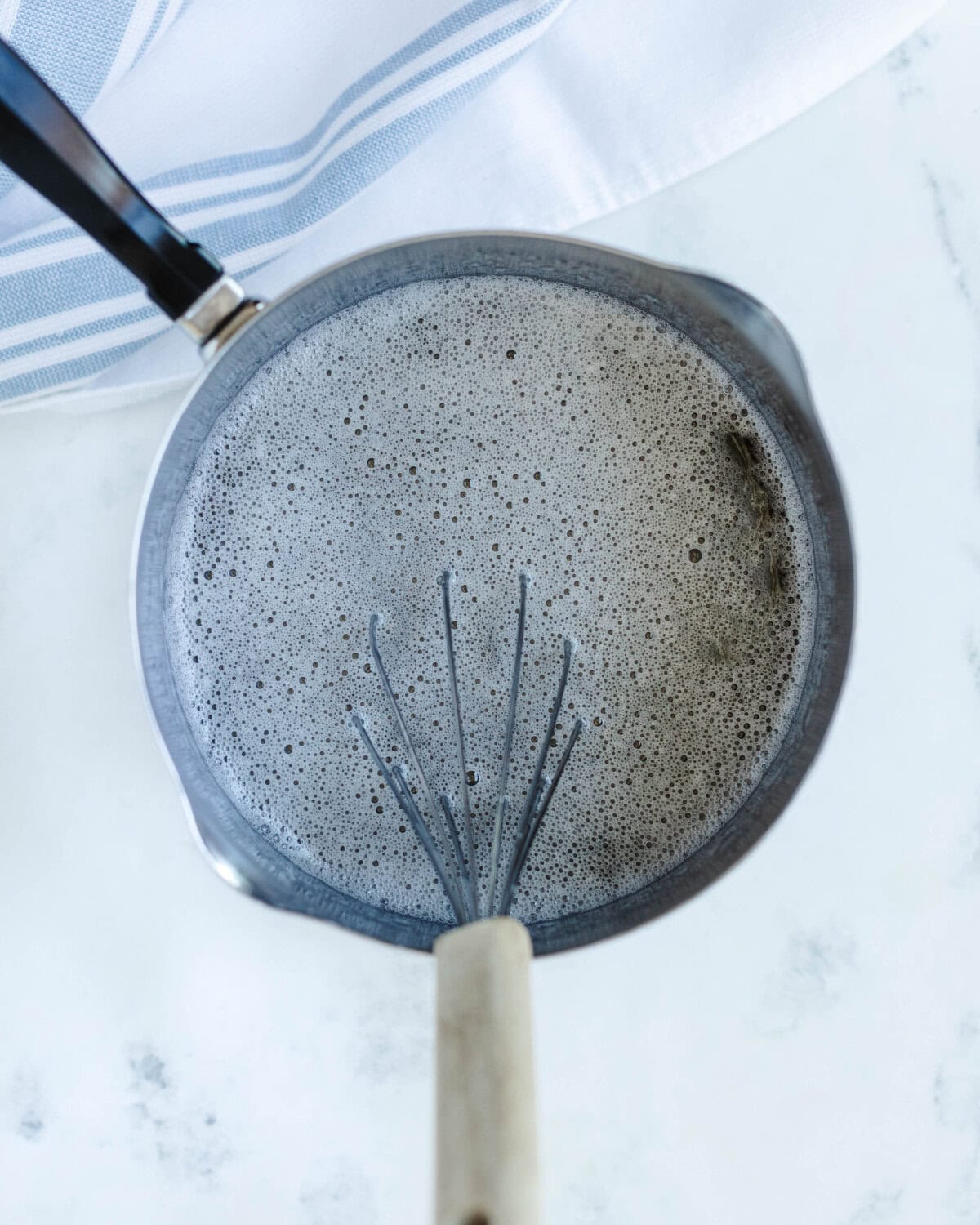 Boiling sugar water in a saucepan.