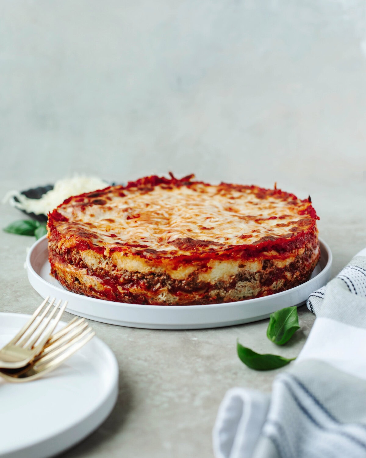 A cheesy lasagna made in the instant pot and served on a white plate.