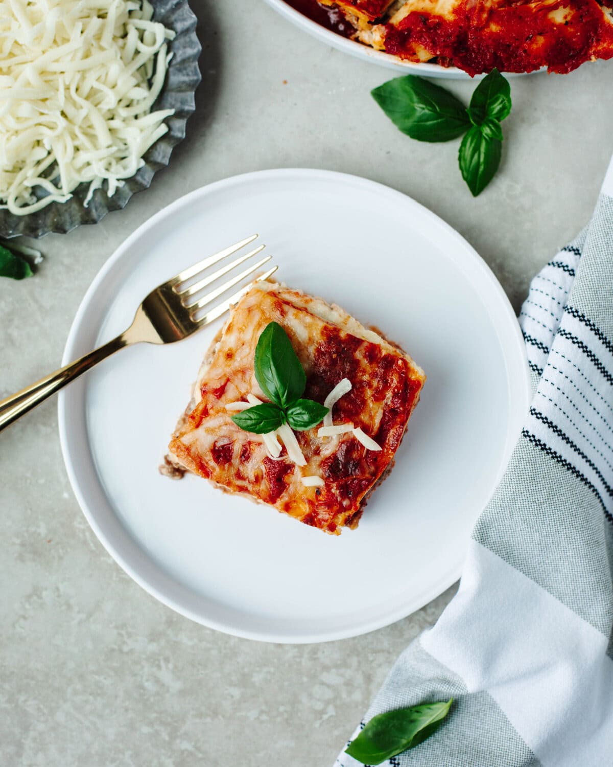 A top view of instant pot lasagna served on a white plate with a fork.