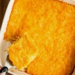 A baked jiffy cornbread casserole with a spatula removing a slice.