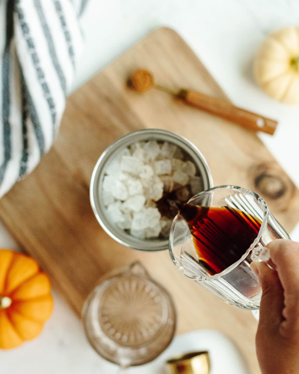 Kahlua added to an ice filled cocktail strainer.
