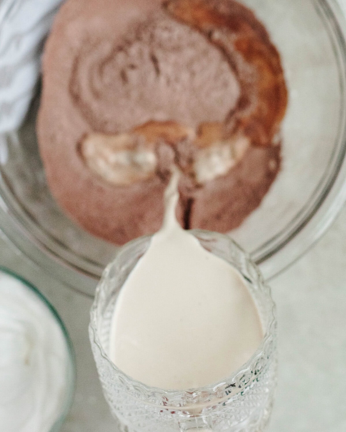 RumChata poured over chocolate pudding mix in a glass mixing bowl.