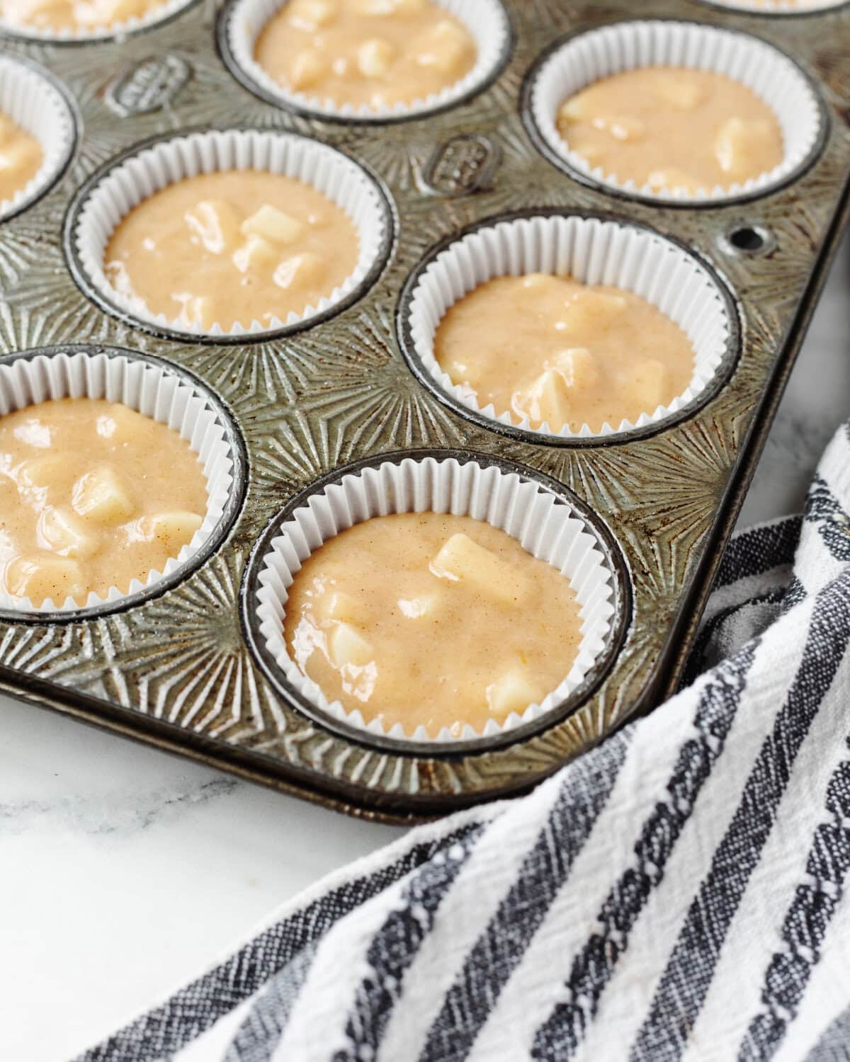 Batter poured into white paper liners and filled ⅔ full in a muffin pan.
