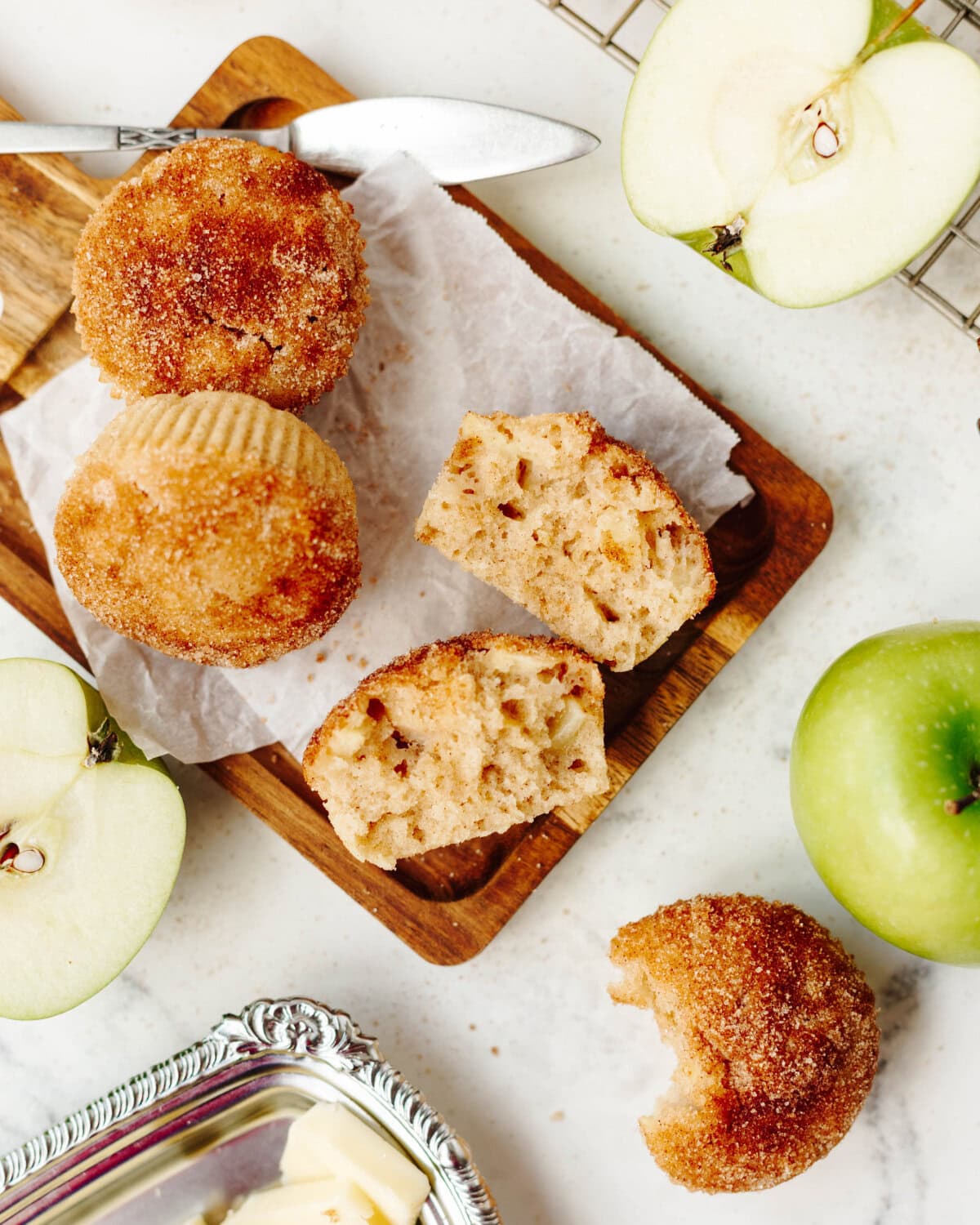 Sliced open snickerdoodle apple muffins showing a tender, moist center.