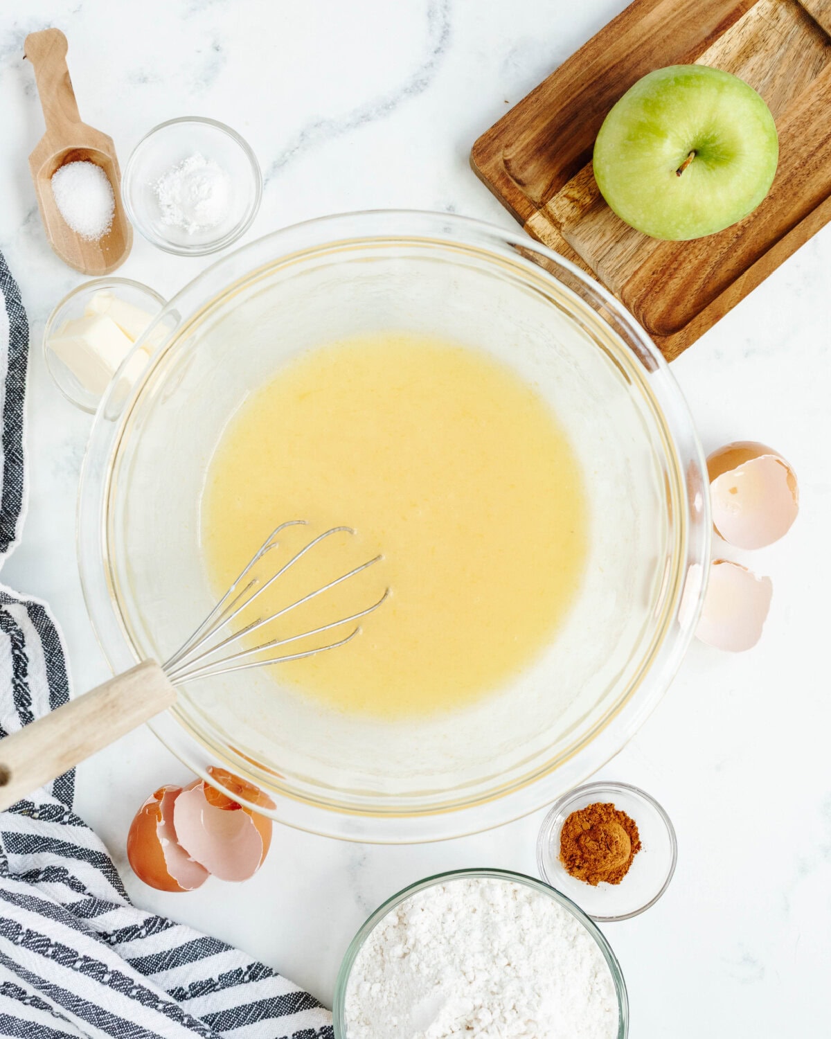 Oil, sugar, eggs, and buttermilk combined in a mixing bowl.
