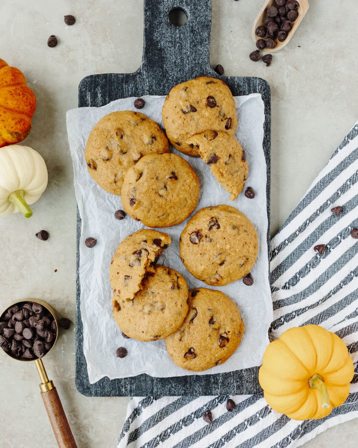 Pumpkin chocolate chip cookies served on a wooden tray.