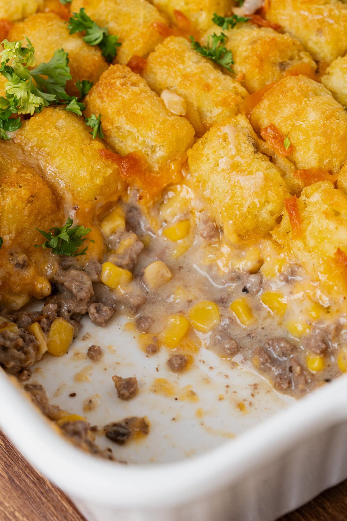 Creamy tater tot casserole in a white baking dish ready to serve.