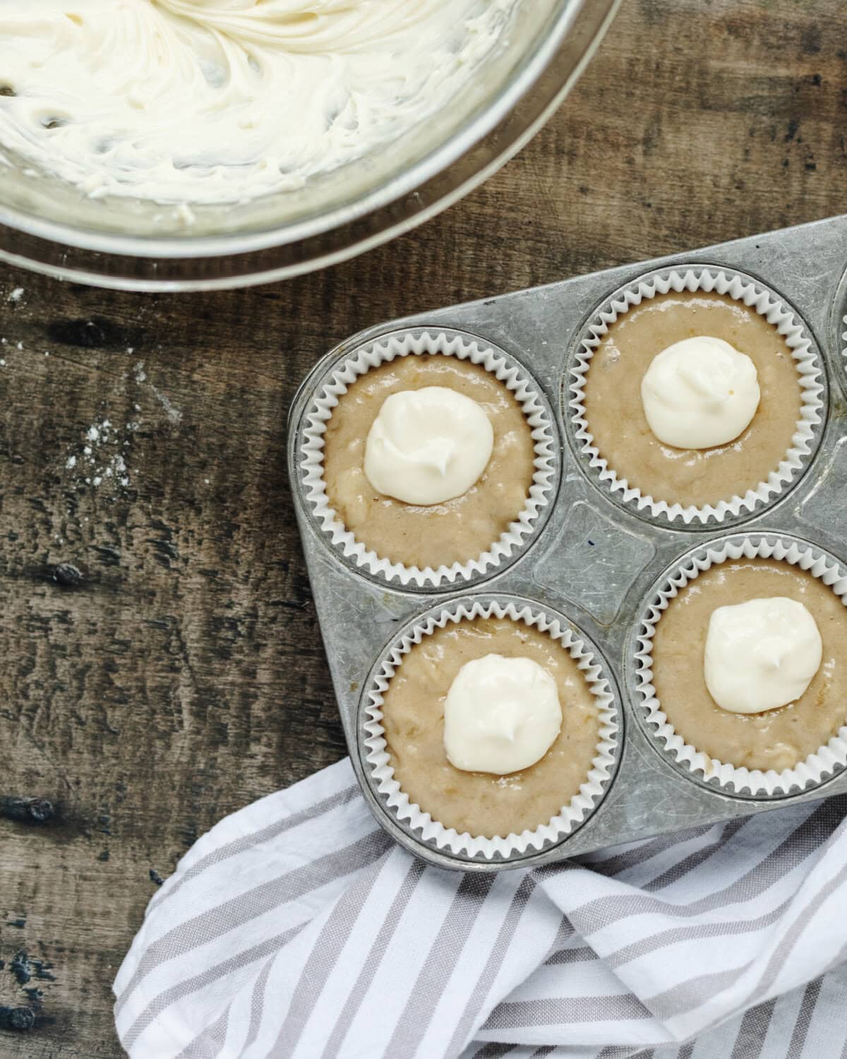 Dollops of cream cheese mixture squeezed into the center of muffin batter.