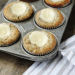 Baked banana cream cheese muffins in a muffin pan.