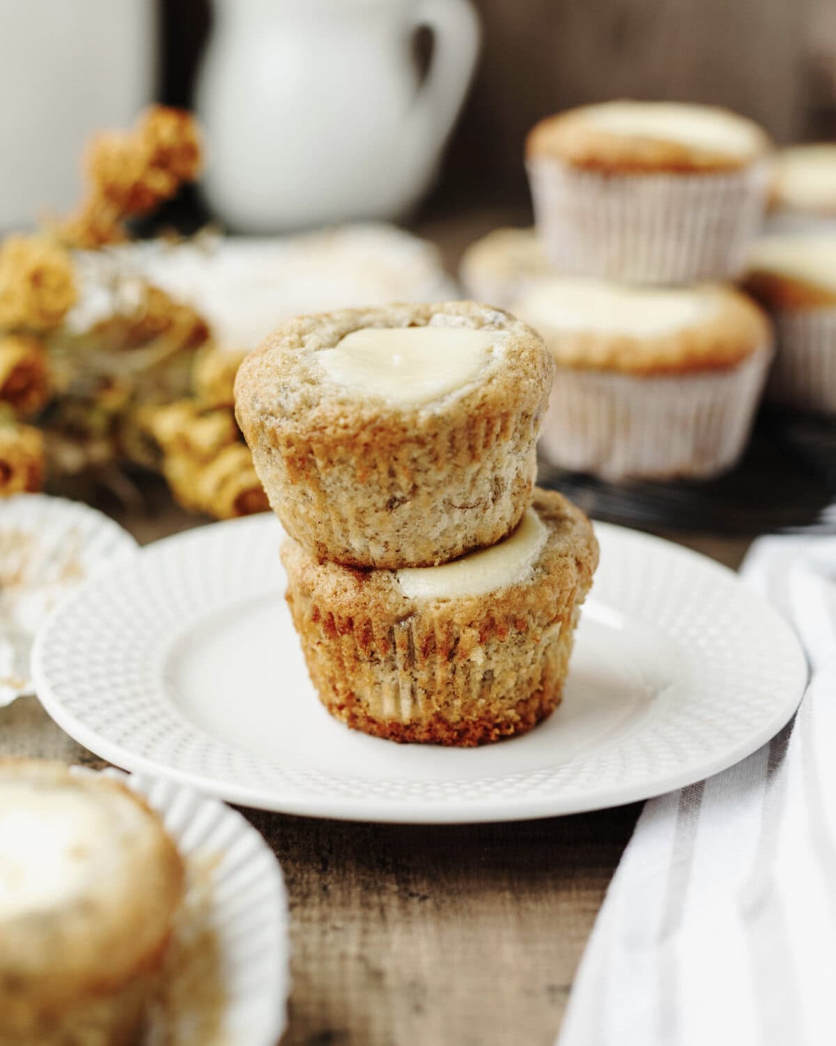 A stack of banana muffins with a cream cheese filling.