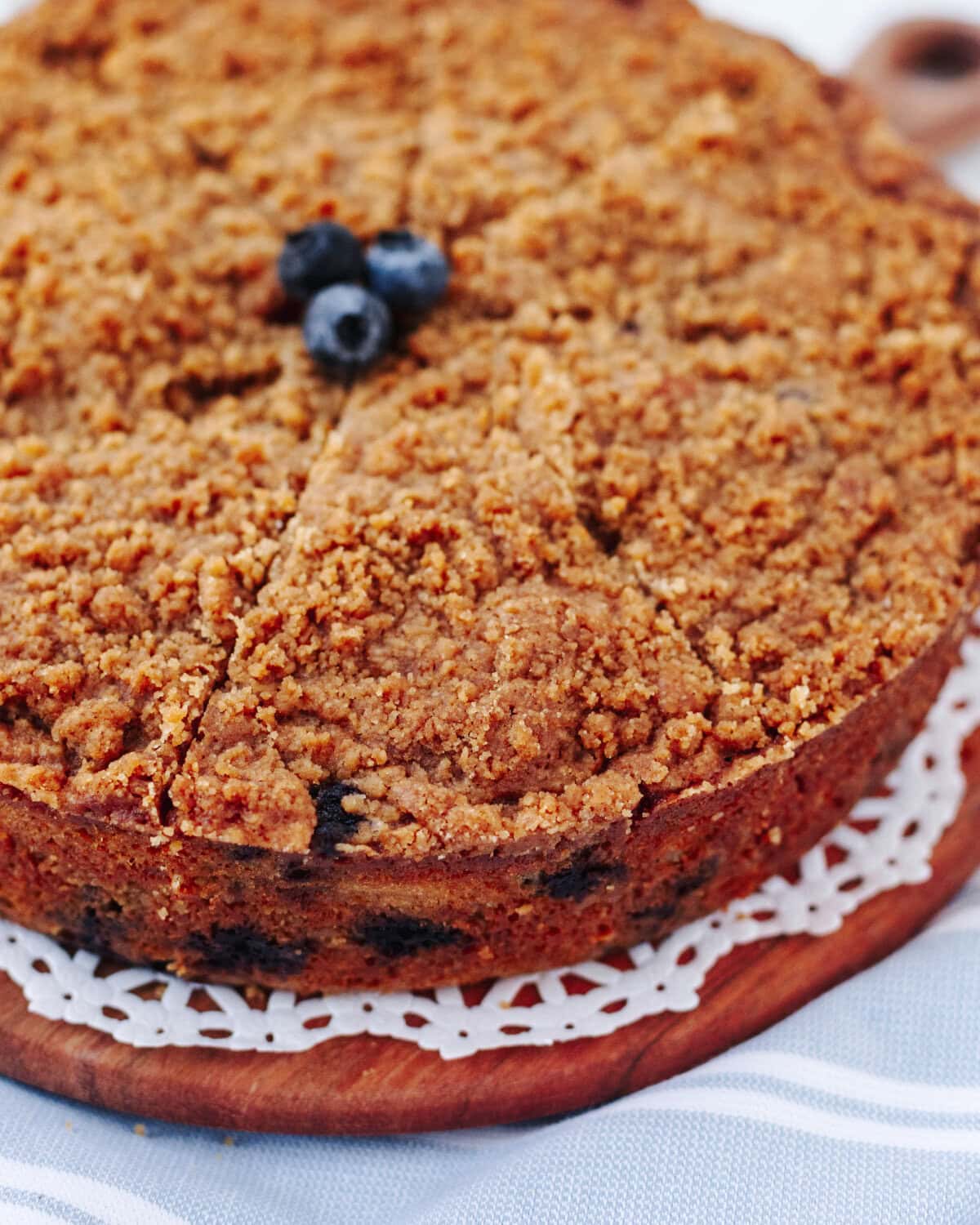 Homemade blueberry banana crumb cake with golden brown streusel topping and fresh blueberries.