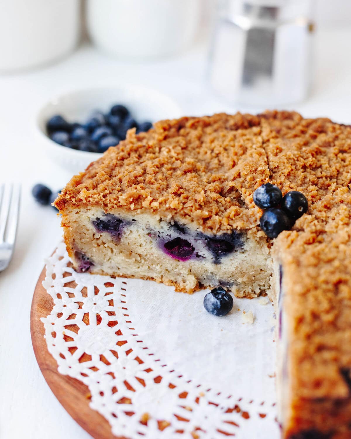 A sliced section of blueberry banana crumb cake showing the tender center texture.