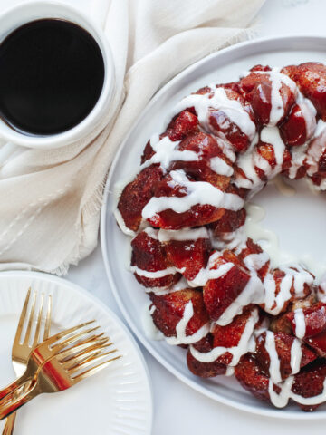 Baked cinnamon roll monkey bread on a white serving plate.