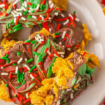 Pieces of cornflake brittle on a white serving plate.