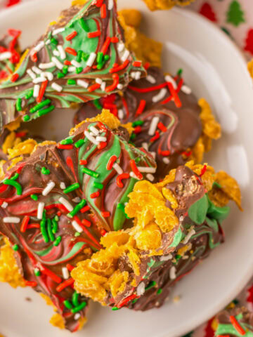Pieces of cornflake brittle on a white serving plate.