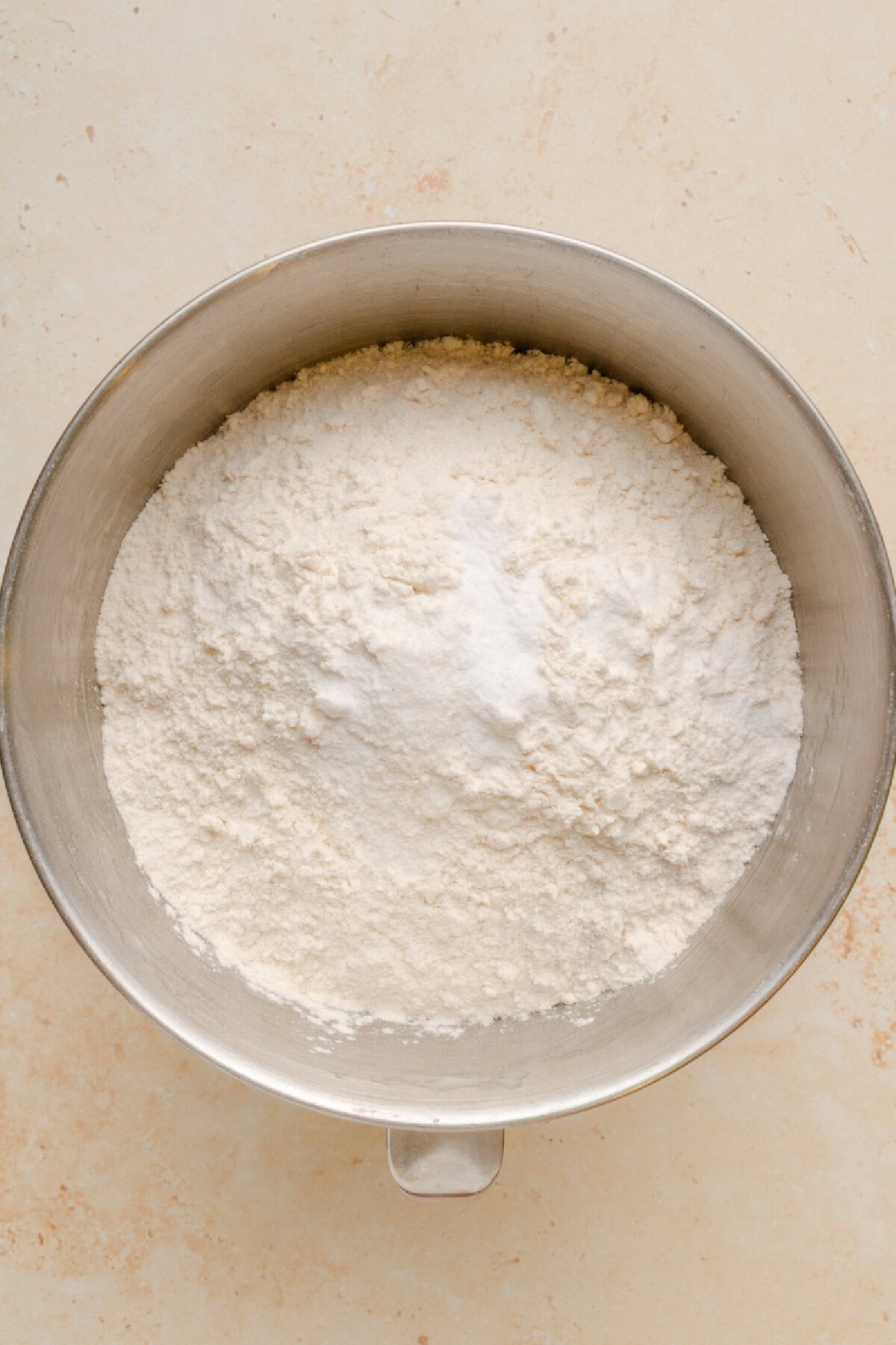 Flour, cinnamon, baking soda, vanilla, and salt combined in a mixing bowl.