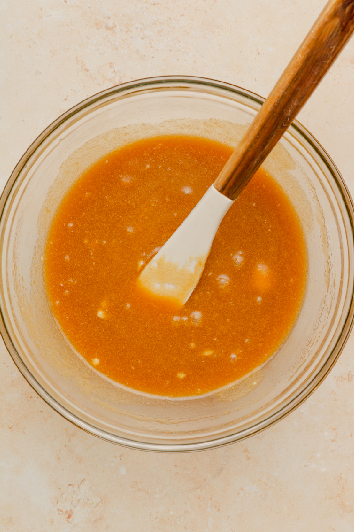 Butter, brown sugar, salt, milk, and vanilla combined in a glass mixing bowl.