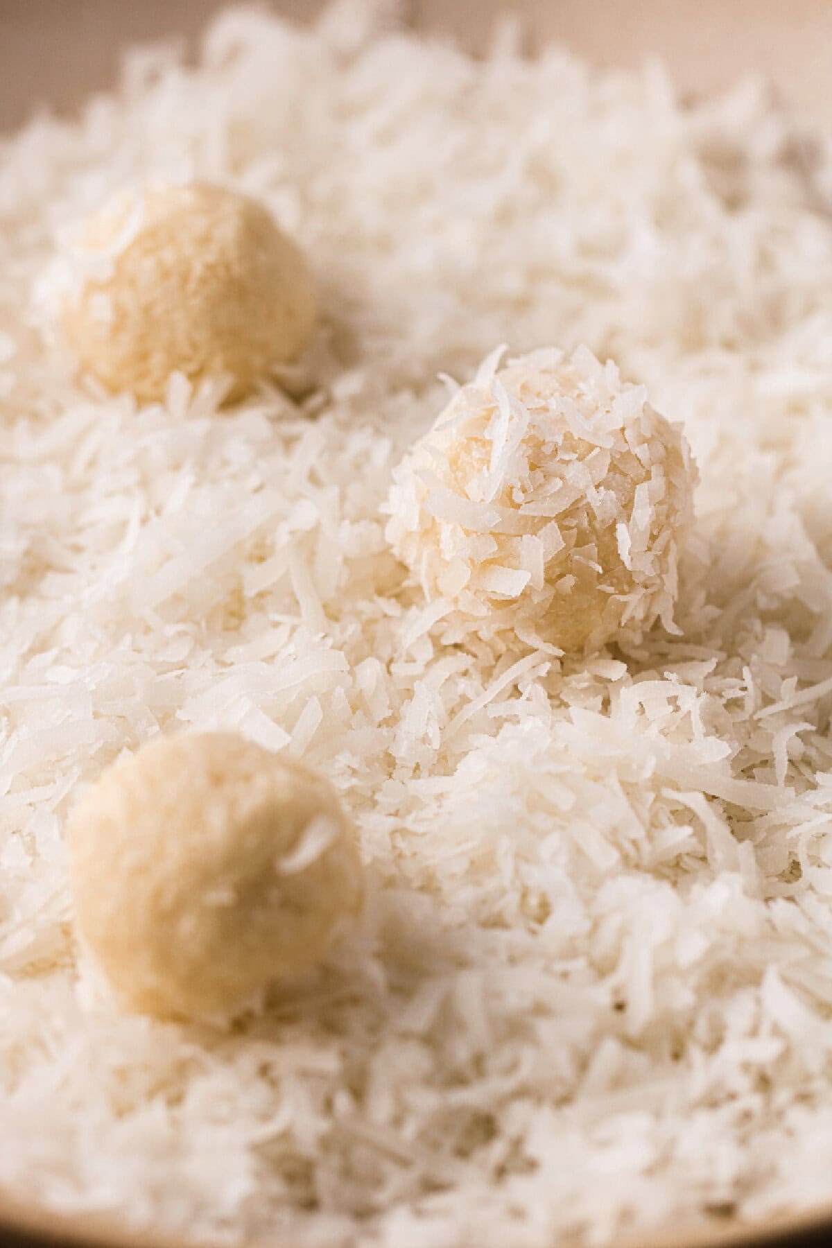 Cookie dough balls rolled through flaked coconut.